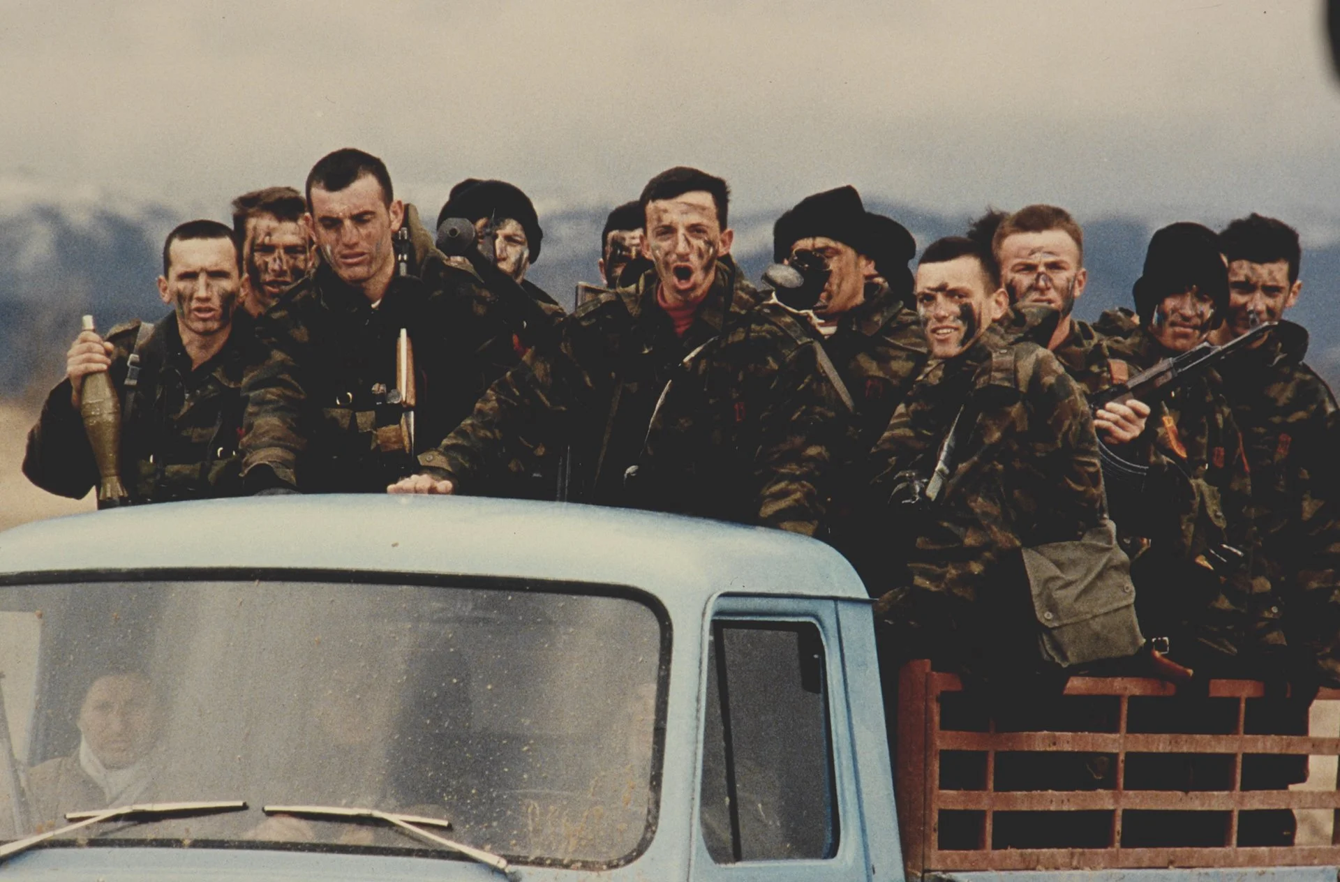 Kosovo Liberation Army fighters are transported to new positions during clashes with Serb forces.