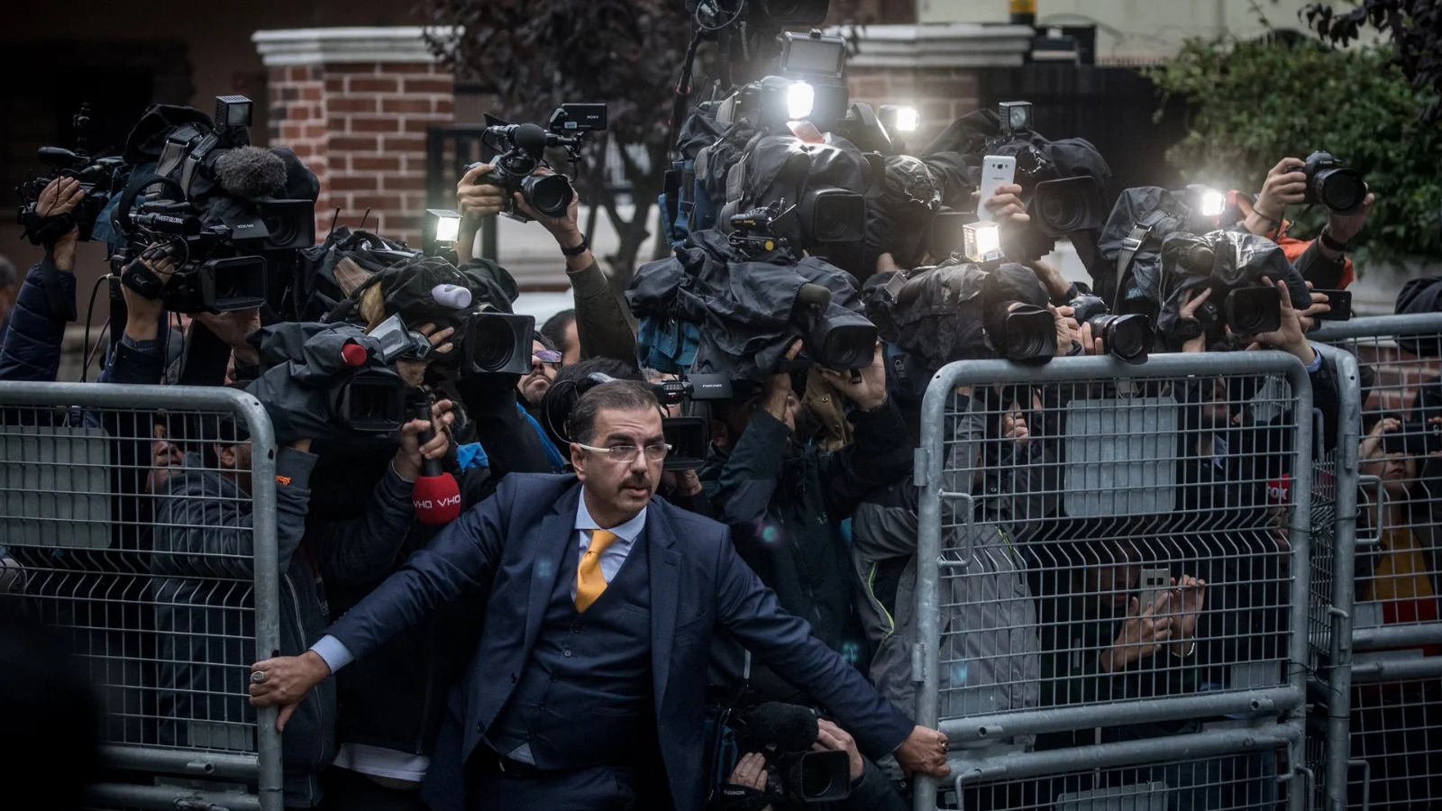 A man tries to restrain the press as Saudi investigators arrive at the Saudi Consulate, amid international reaction to the disappearance of journalist Jamal Khashoggi.