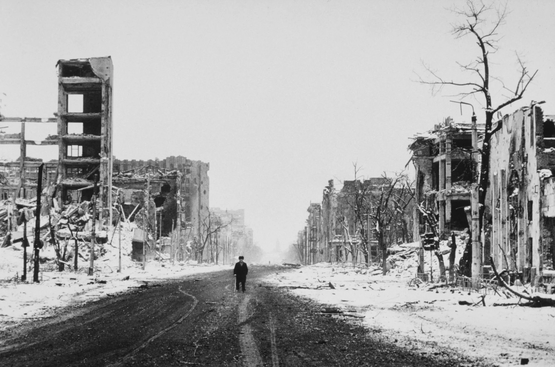 An elderly man walks defiantly down a street in Grozny, risking death from sniper fire, as Russian troops and Chechen separatists continue to fight for the city.