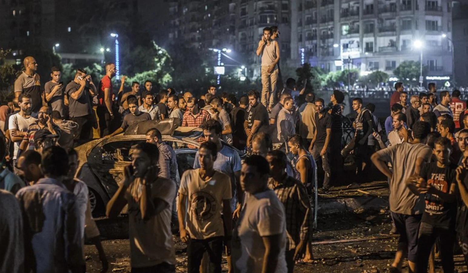Onlookers gather at the site of a car bomb attack.
